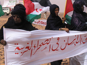 Somewhere south of Mahbes, Western Sahara, in the freed zone. Sahrawi women in the II International march against the Moroccan built wall that divides western Sahara. The longest wall built on Earth, this wall consists of a long wall with a berm, barbed wire, millions of landmines and electronic systems, survived by thousands of Moroccan soldiers.By Western Sahara (Sahrawi women against the wall of shame) [CC BY-SA 2.0 (http://creativecommons.org/licenses/by-sa/2.0)], via Wikimedia Commons